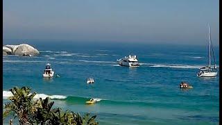 Clifton kayakers playing in waves on a sunny beach day. From Clifton 4th Livestream webcam