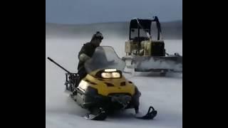 Skandic Superwides pulling a Dozer across Frozen Lake