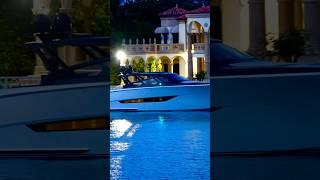 The gorgeous Wajer 77 Lux Yacht passing a beautiful mansion overlooking the Haulover Inlet sandbar