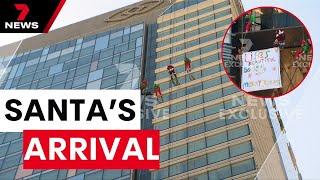 Santa’s daring descent down a skyscraper in Darling Harbour | 7NEWS