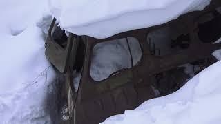 THE THROWN ARMORED CAR IN THE RIVER ON THE MOUNTAIN TCHEGET SLOPE, THE CAUCASUS RUSSIA.