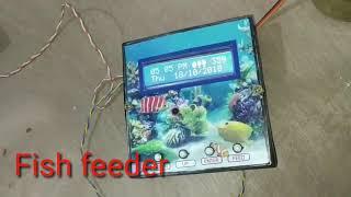 Automatic aquarium fish feeder with clock, calendar, alarm, and fish tank temperature