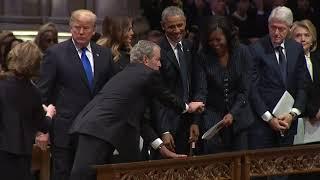 George W Bush sneaks Michelle Obama candy before father's funeral