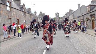 Chieftain leads the massed Pipes and Drums on the march to 2023 Dufftown Highland Games in Scotland