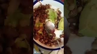 Eating githeri with avocado, MercyNguku The World Traveller 