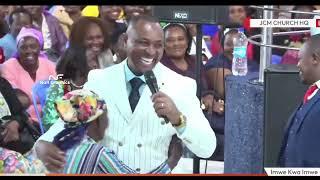 Bishop Ben gives this 5k to this shosho who walked to church from Kiamaiko