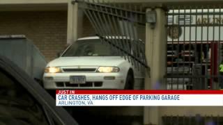 Car crashes, hangs off edge of parking garage