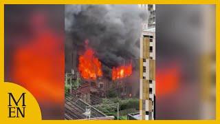 Huge blaze erupts at Hotspur Press in building in Manchester