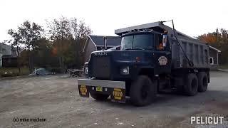 Mack Dump Trucks unloading gravel