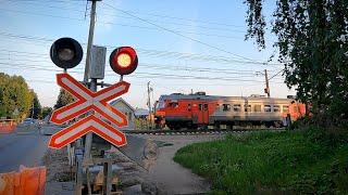 Railway crossing with a barrier and barriers / Video about trains and railways