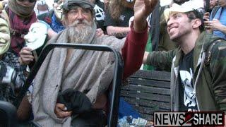 Anonymous Gives Money, Food to Homeless Man at Million Mask March