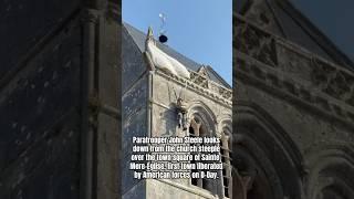 Paratrooper John Steele looks down from the church steeple on the town square of Sainte-Mere-Eglise.