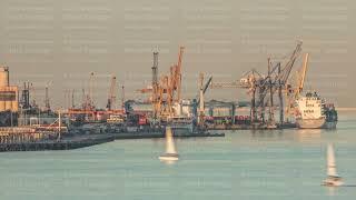 Container cargo ship during docking at industrial port with cranes aerial timelapse. Lisbon