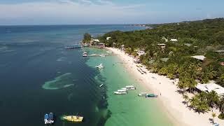West Bay Beach, Roatan Honduras: Crystal Clear Water & White Sand Paradise (4K Drone Tour)