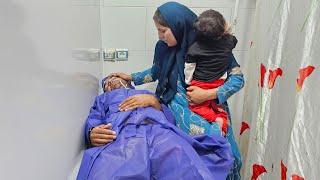 "A displaced woman visiting her husband in the hospital"