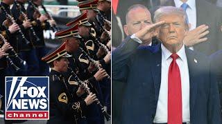 'Army Goes Rolling Along' as Trump salutes troops at military parade