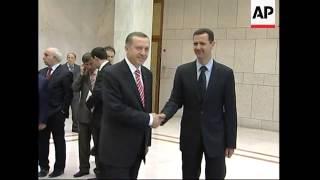 WRAP Erdogan meets FM at airport; President Assad; photo op