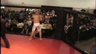 Double knock out when two fighters bust through cage door at MMA fight