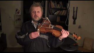 Vladimir Pliassov  shows the violin of his own invention.