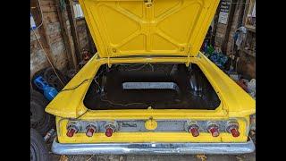 Rocker guarding a trunk.  The 1962 Comet gets its trunk cleaned up.