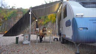 A girl enjoying delicious solo camping in the rain, adventure in a caravan