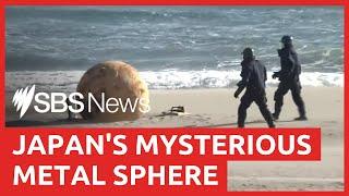 Japanese officials remove mysterious washed up sphere but what was it? | SBS News