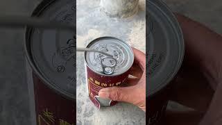 The process of quickly opening a metal can using a spoon