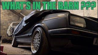 What cars are in the barn?