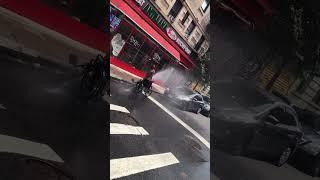 A normal day in NYC during the summer. People taking a bath right outside with a fire hydrant.