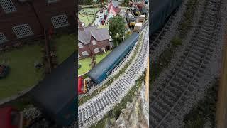 Passing the village a top and tail class 66 Nuclear flask wagon train with barrier coaches.