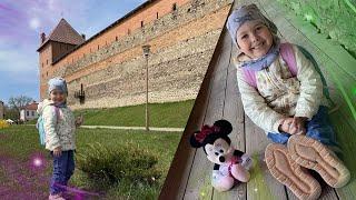 Margo visits ancient castle and makes many photo with toys