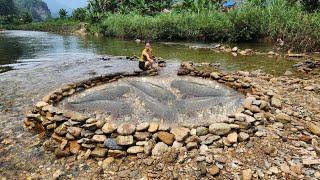 A very unique way to trap fish, Ana arranges rocks to create a trap to catch fish in the stream.