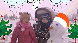 Mubina and Family play with snow and sculpt a snowman