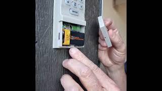 Removing Liftmaster garage door keypad battery cover.