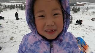 Sledding during the first snow storm of 2025