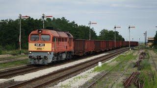 Diesel locomotive Szergej M62-203 passes through Börgönd station with a freight train