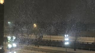 Snowfall and blizzard in Moscow in the bright spotlights