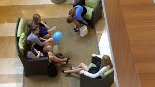 Candid Shoeplay of girls relaxing their feet at the mall after seminar