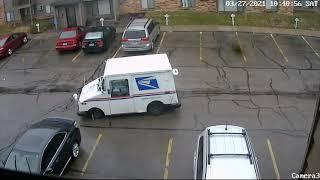 How difficult is it to look? Car backs into postal vehicle truck.