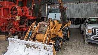 Case 580E backhoe pushing snow in the January 2025 snowstorm.