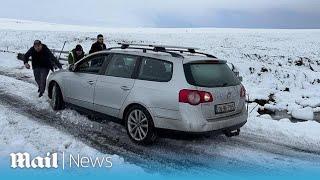 Weather chaos: Motorists in Ireland struggle with car stuck in the snow