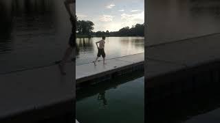 Kid swims in lake with only his underwear on