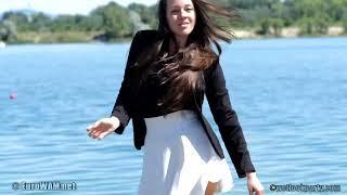 Girl in a white skirt in the lake and on the beach