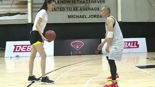 Tall Woman Plays Basketball with Shorter Guy