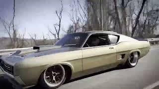 Wayne Carini driving past in the Talladega Torino