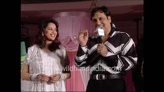 Govinda reads out a handwritten poem to Madhuri Dixit on stage