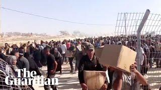 Gunfire heard as thousands rush to receive aid at Gaza distribution centre