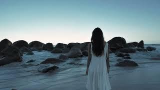 Videli Free Footage - Woman walking on beach towards boulders