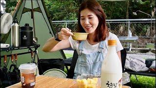 A girl camping alone, staying in a tent and listening to the sound of flowing water in the valley