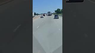 Semi-truck driver survives crash off overpass and explosion; driver of car flees scene